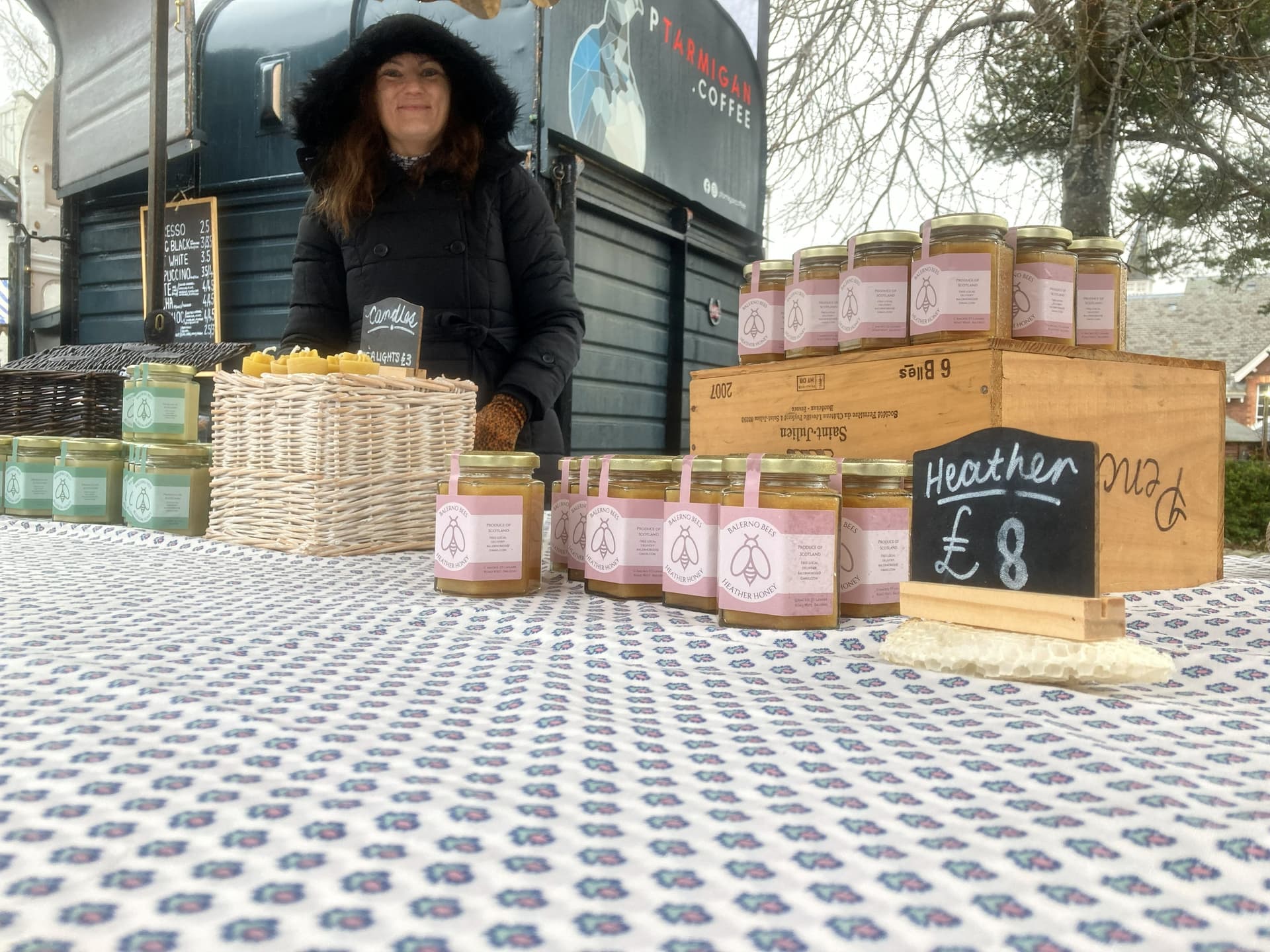 Balerno Bees outdoor farmers market stall displaying rows of heather honey jars — an Edinburgh producer selling direct to the public